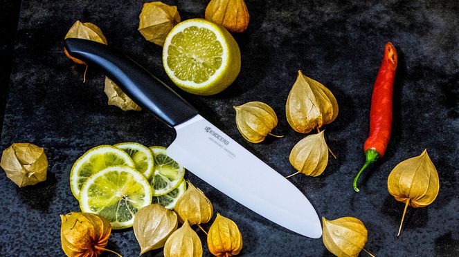 
                    Kyocera Santoku cutting an orange